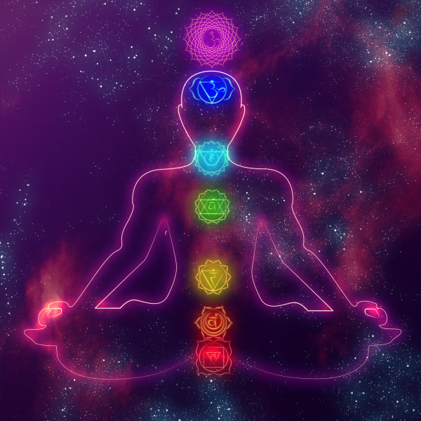Person meditating with vibrant energy fields around them