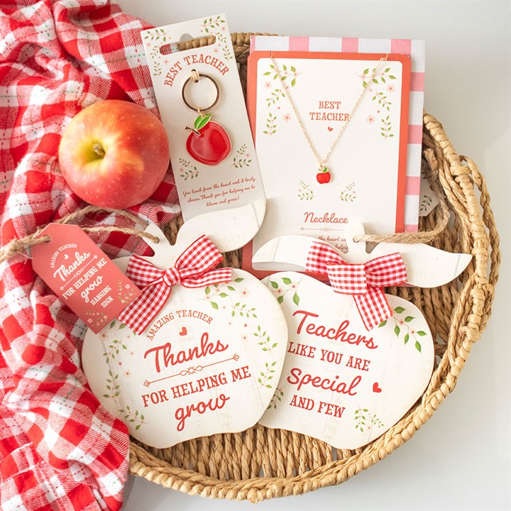 Charming apple hanging decoration for teachers displayed with gift items, ideal for showing appreciation and love in the classroom.
