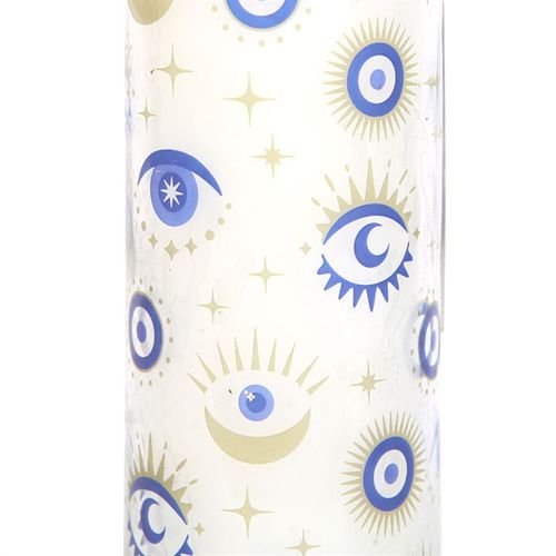 Cylindrical candle with eye pattern.