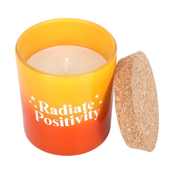 Radiate Positivity lemon candle in a vibrant yellow and orange container with a cork lid, perfect for uplifting ambiance.