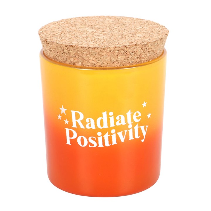 Radiate Positivity Lemon Candle in a vibrant yellow and orange glass jar with a cork lid for uplifting ambiance