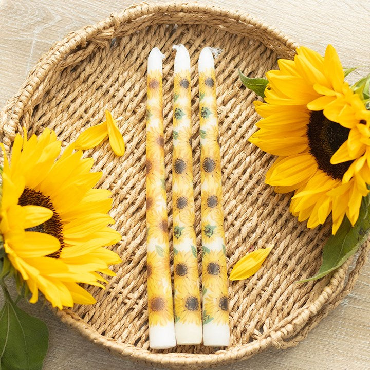 Set of 3 sunflower taper candles, perfect as summer decor candles, displayed with vibrant sunflowers in a woven basket.