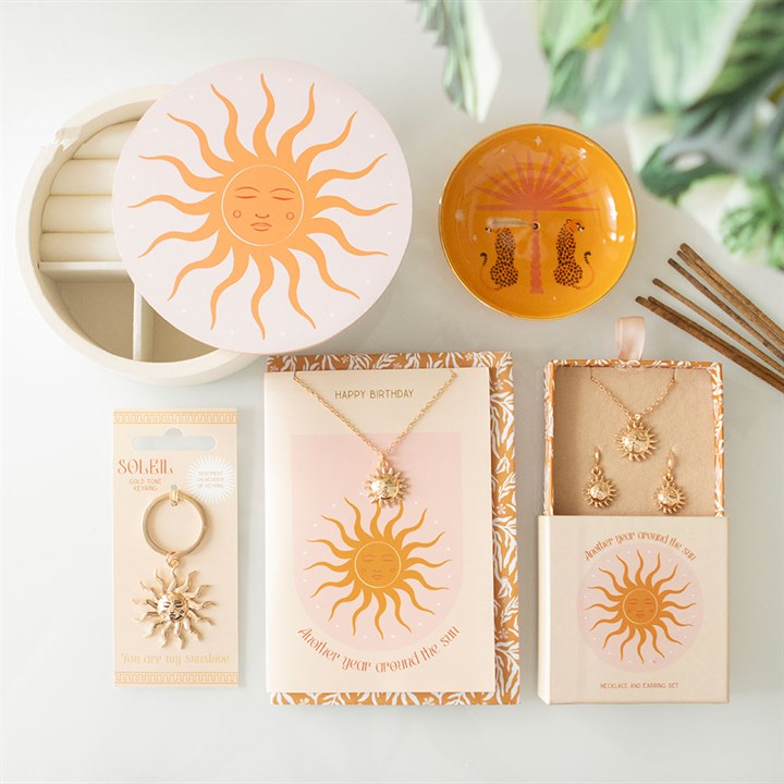 Sun Earring and Necklace set displayed with a decorative box, featuring vibrant sun designs and elegant packaging