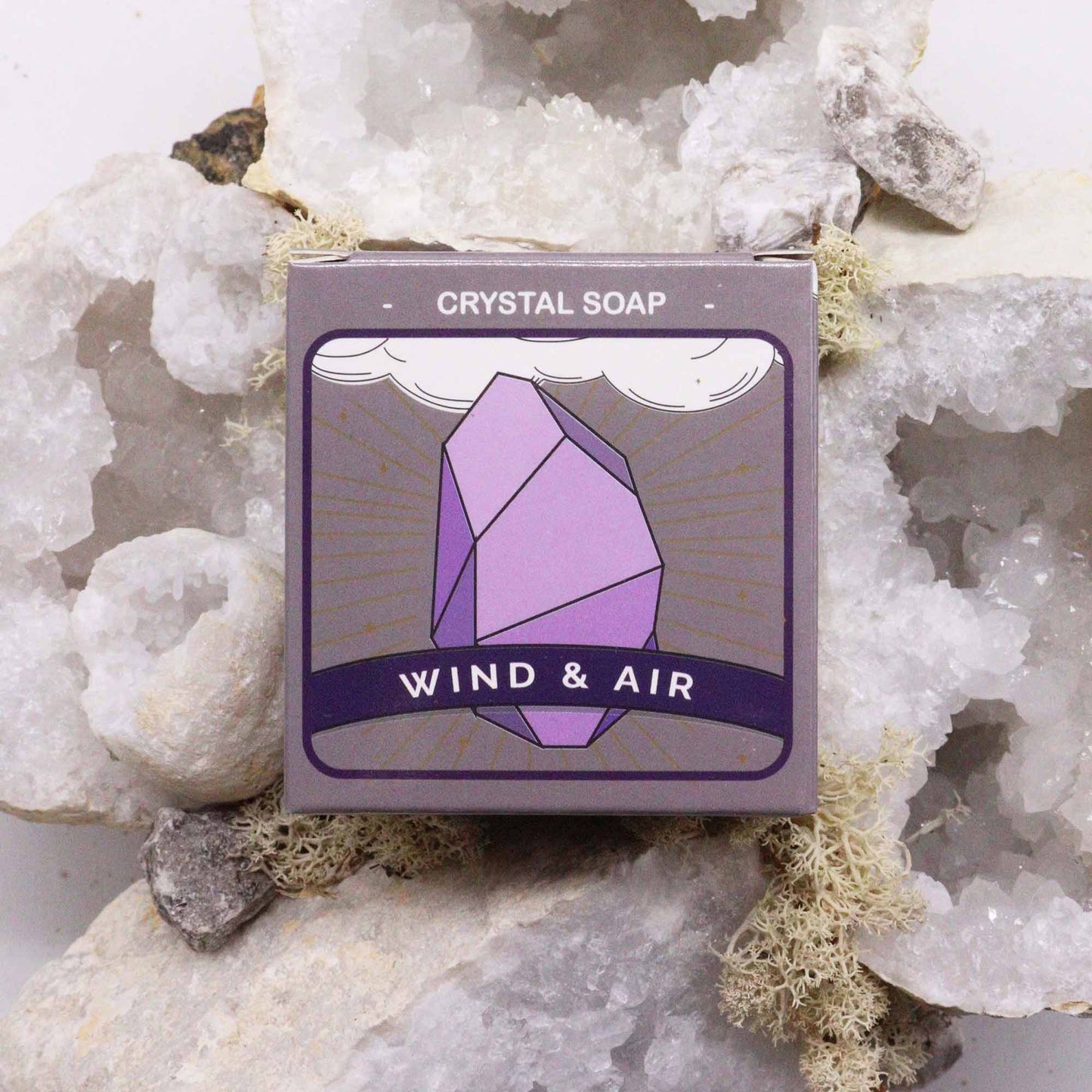 Air element crystal soap in a decorative package on a bed of crystals for spiritual cleansing