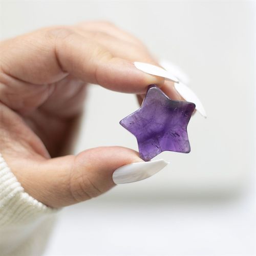 Amethyst crystal star gift held in hand, perfect for thoughtful gestures and good luck charms