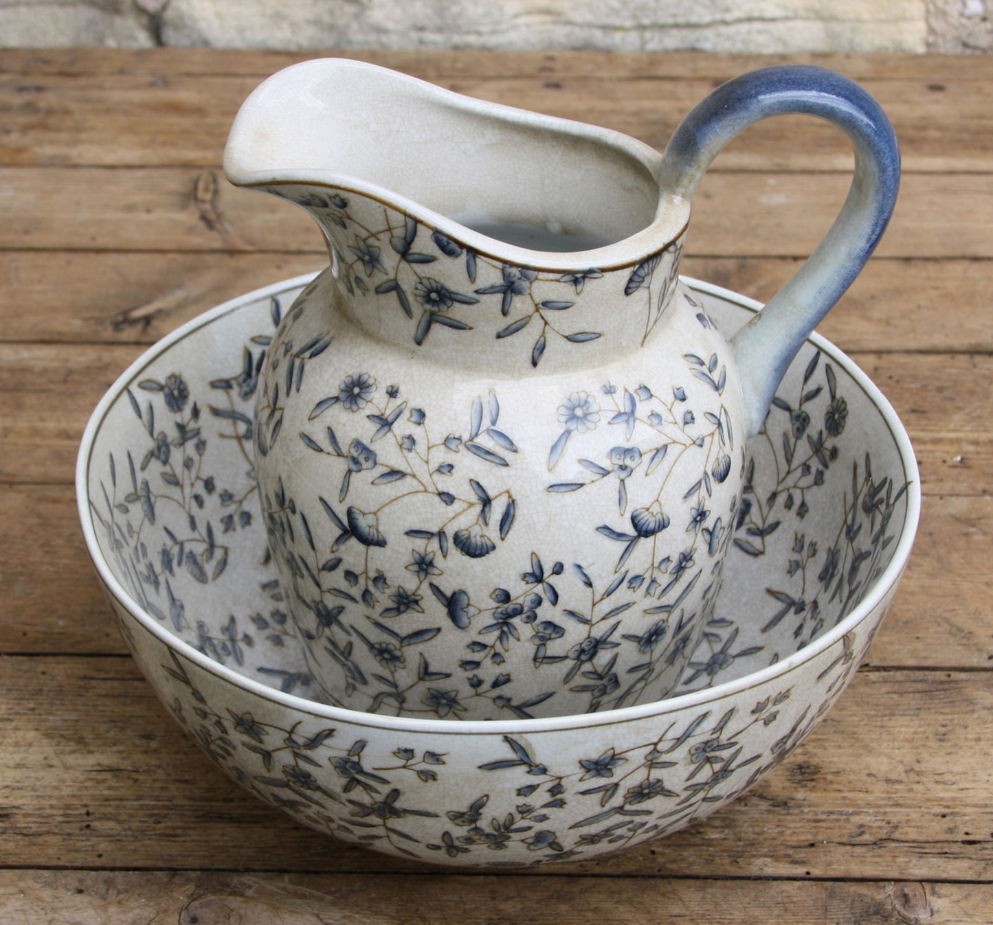 Geko Products blue and white decorative jug with floral design and matching basin on wooden surface