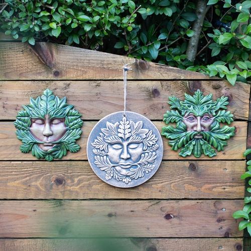 Bronze Green Goddess Terracotta Plaque hanging decoration amidst greenery