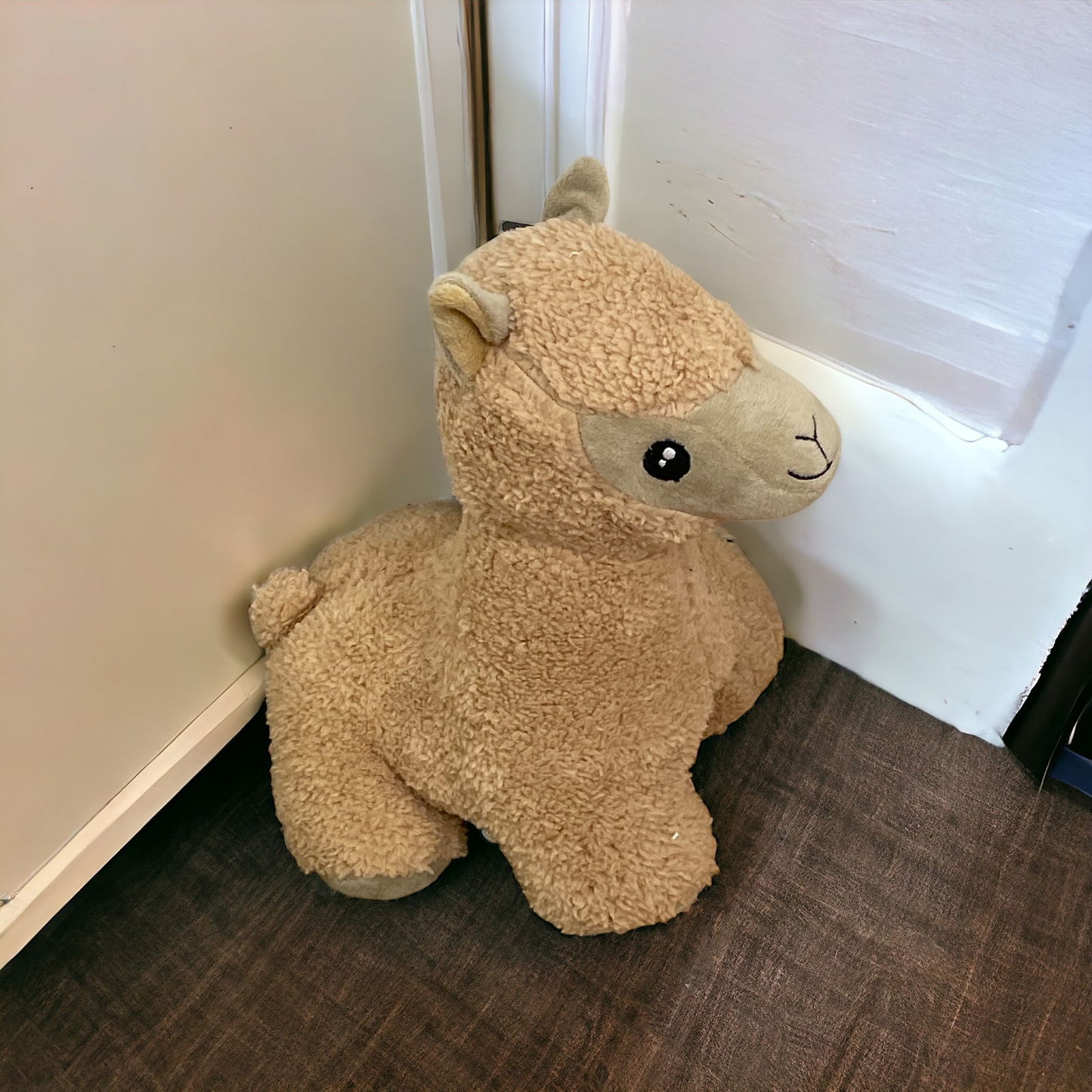 Brown Alpaca Door Stop plush stuffed animal positioned against a door on carpet floor