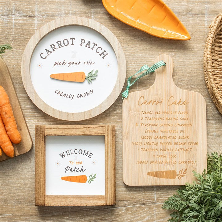 Carrot Patch wall decor featuring round and rectangular plaques with carrot illustrations and text