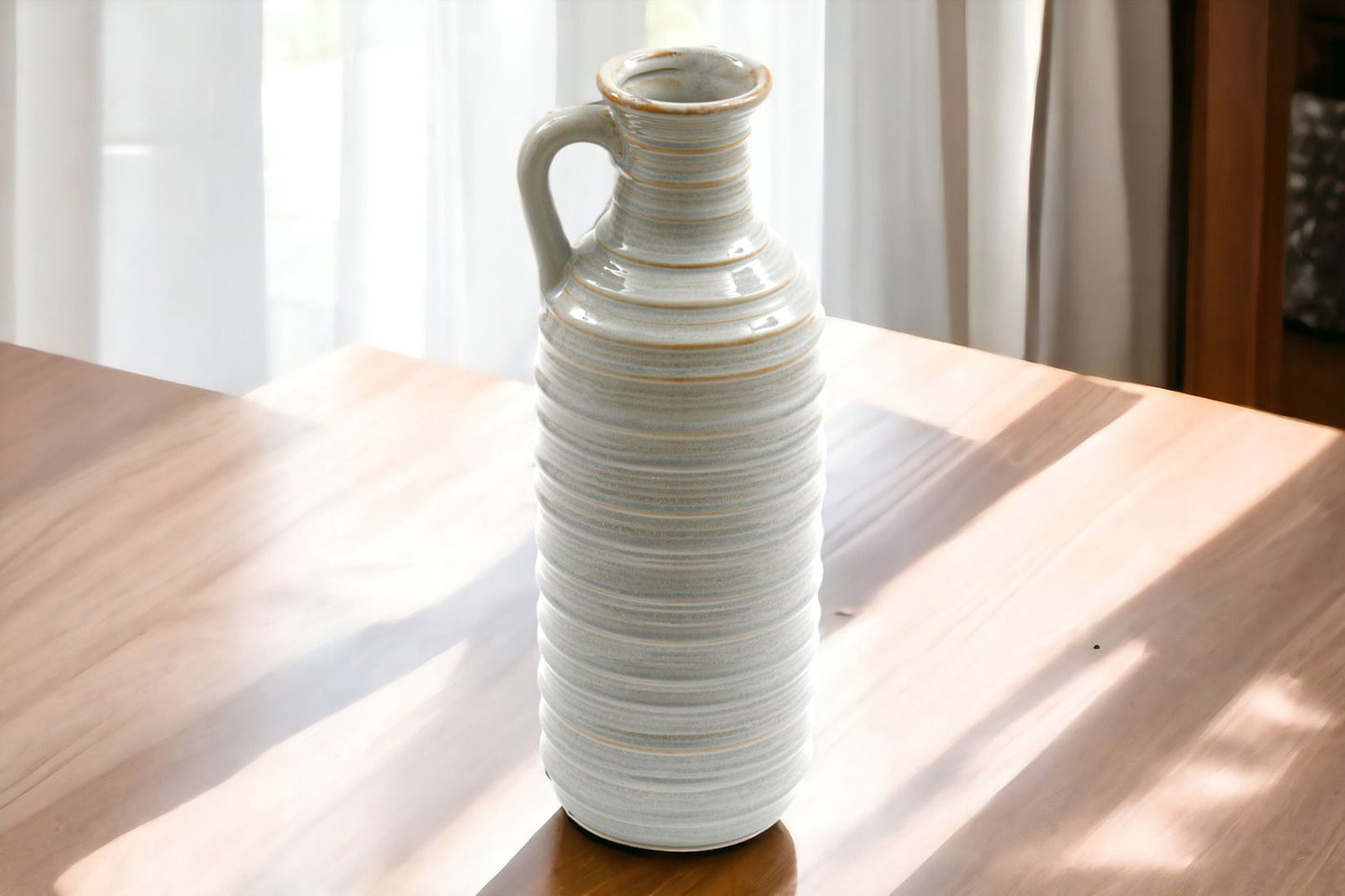 Geko Products ceramic ribbed vase with handle in white and beige tones on wooden table