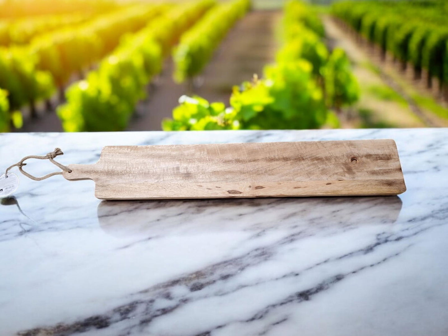 Engraved horse chopping board by Geko Products displayed on marble countertop with outdoor vineyard background