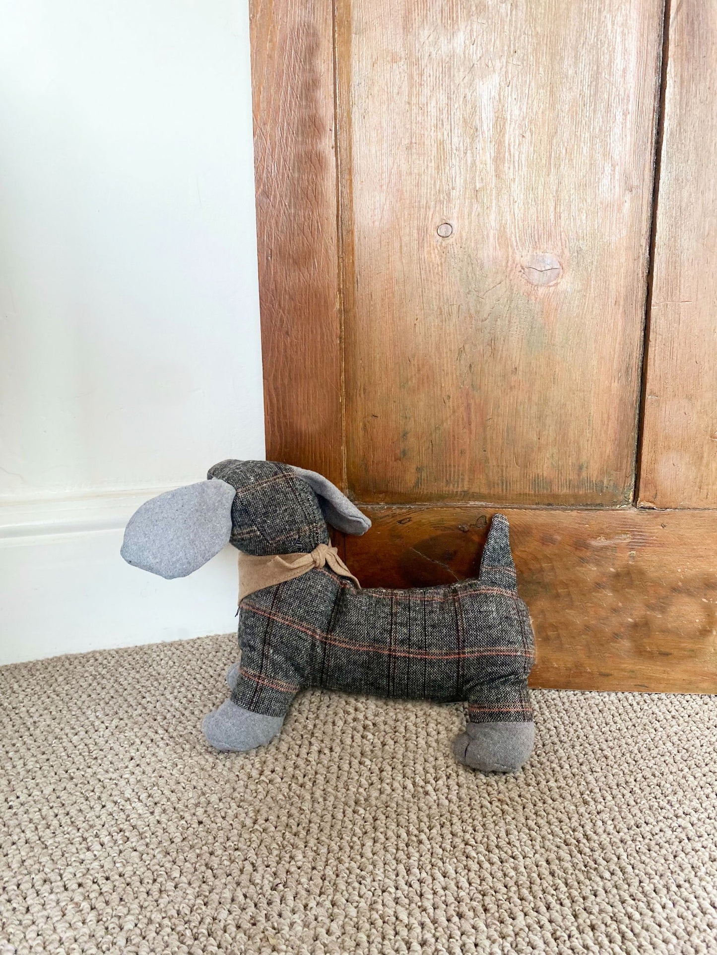 Fabric dachshund doorstop in plaid design, perfect for stylish home decor and door security