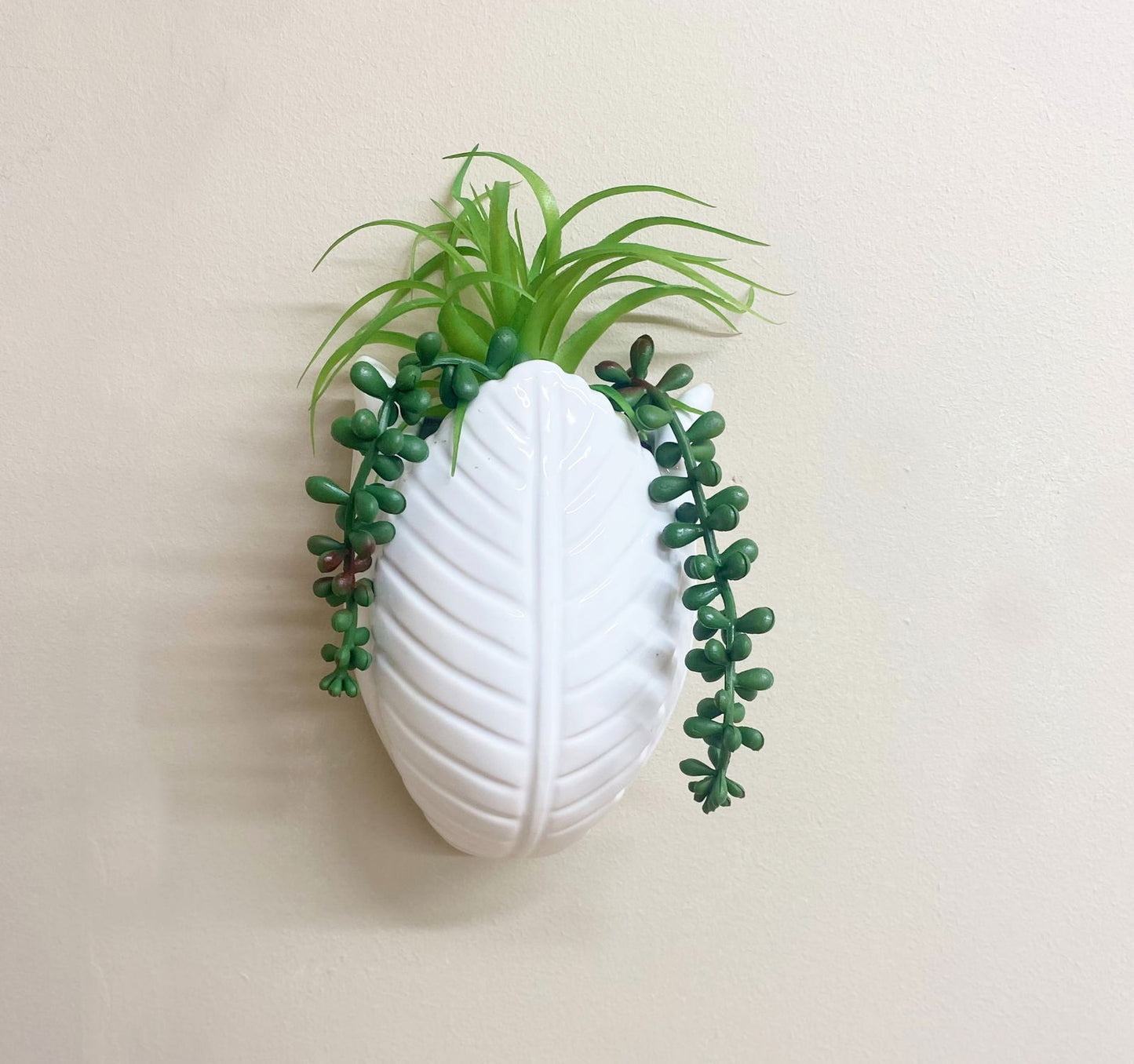 Geko Products faux succulents wall decor with green artificial plants in white leaf-shaped vase