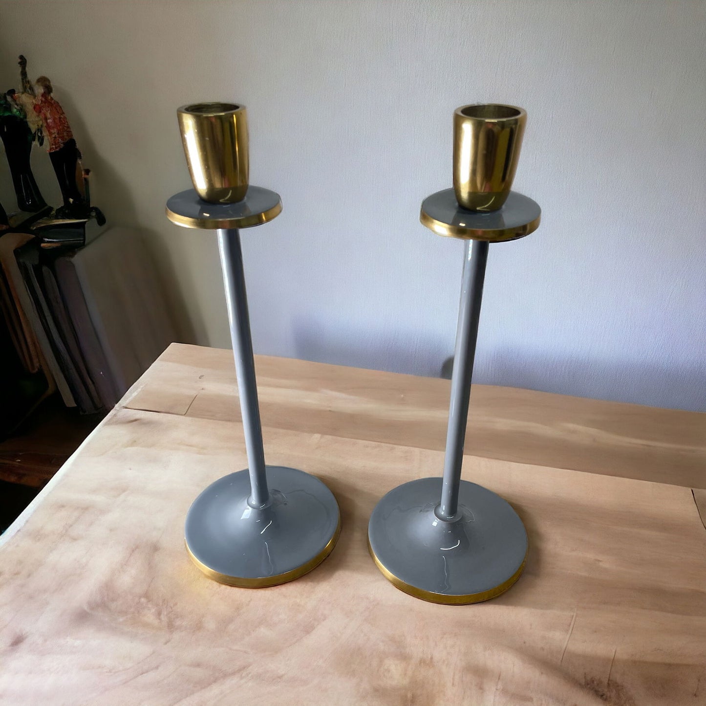 Glossy grey candlestick set with gold accents on a wooden surface by Geko Products