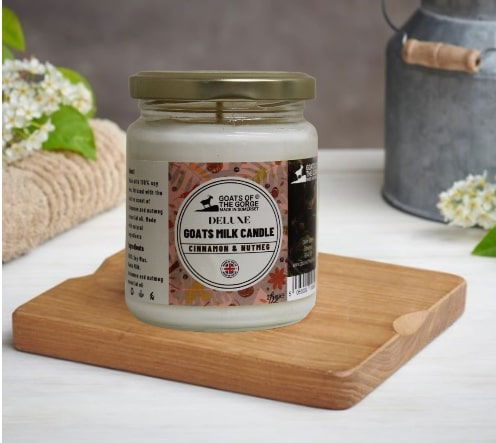 Geko Products Cinnamon Nutmeg Goats Milk Candle in decorative jar with festive label and autumn decor