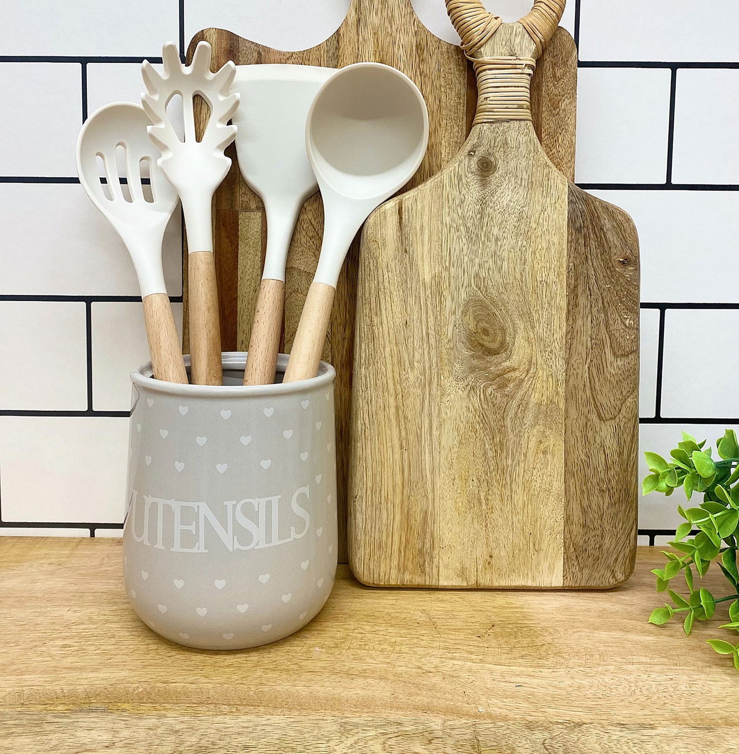 Geko Products hearts design utensil holder in gray with white kitchen utensils and wooden handles