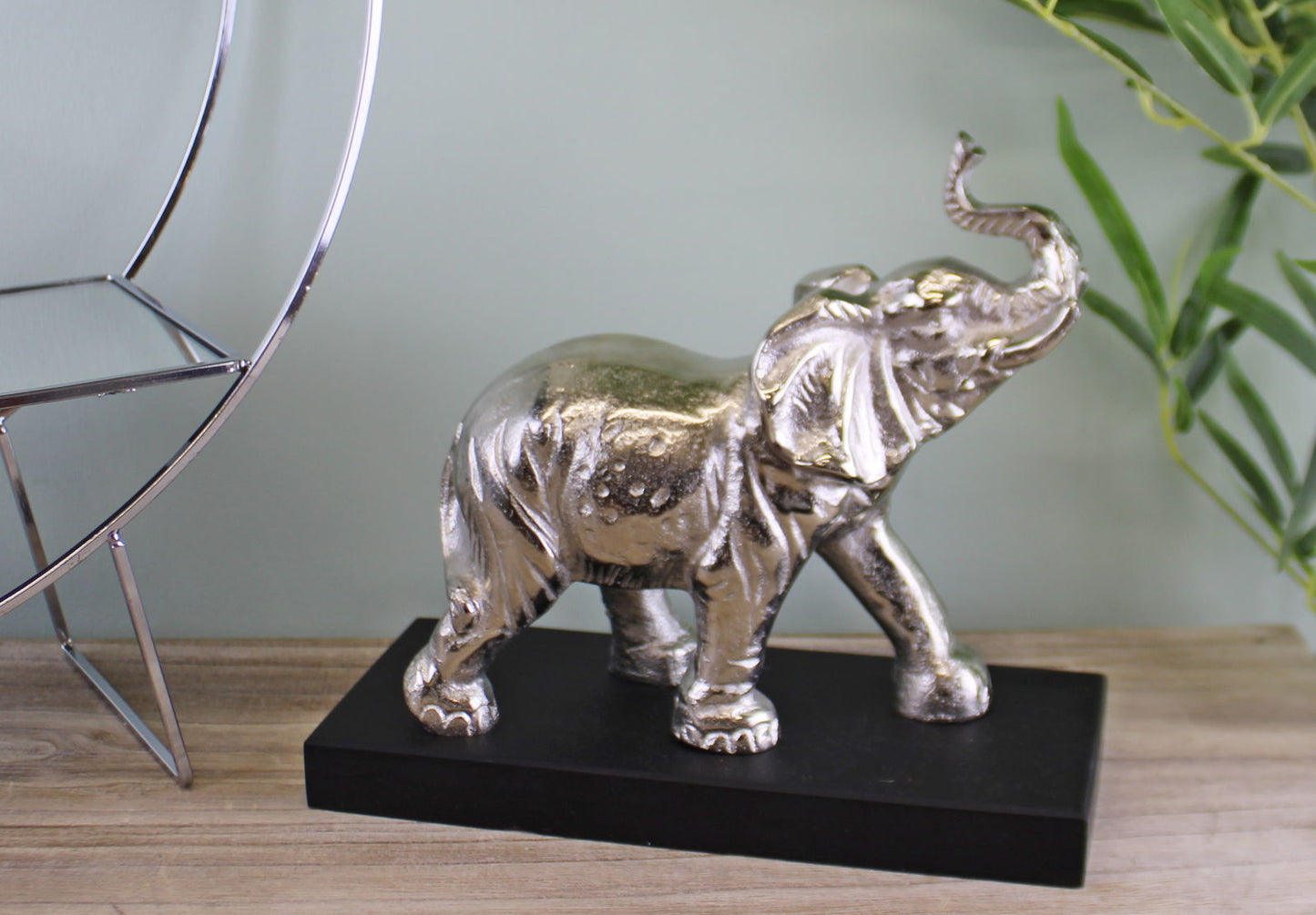 Large ornamental elephant decor in silver finish on black base by Geko Products
