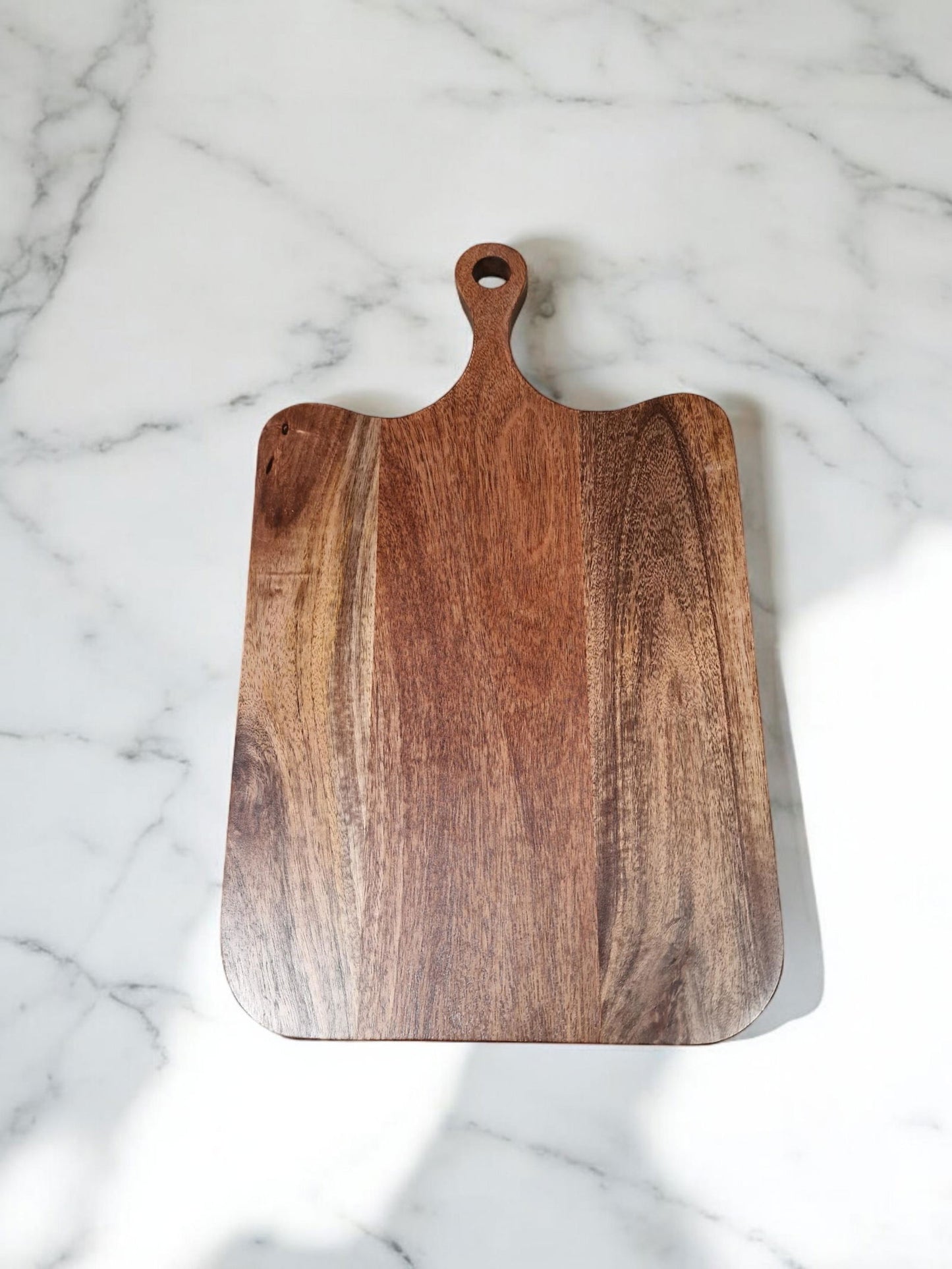 Geko Products large wooden chopping board with handle on white marble surface