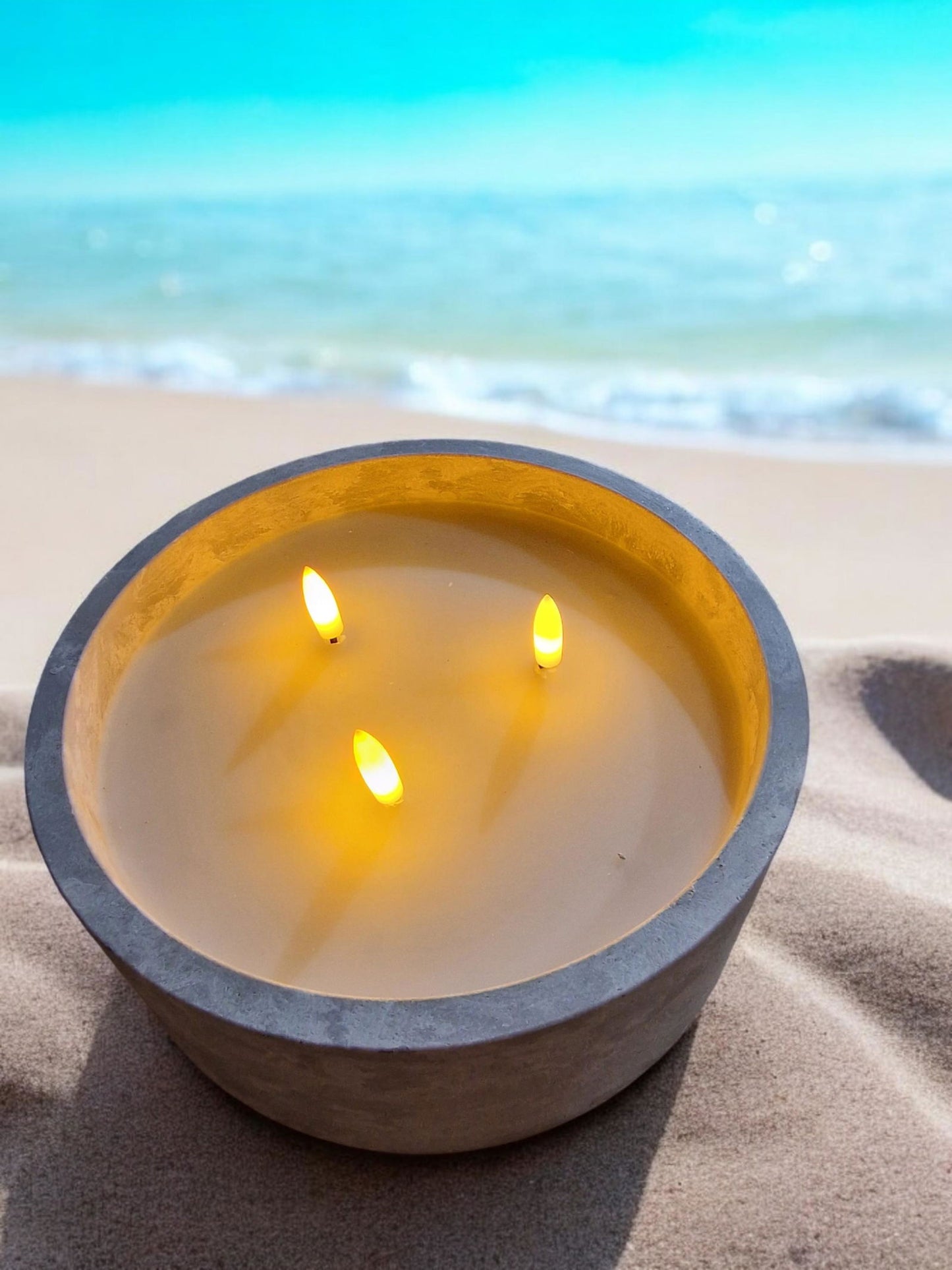 Geko Products LED cement candle holder with three flickering flames on sandy beach background