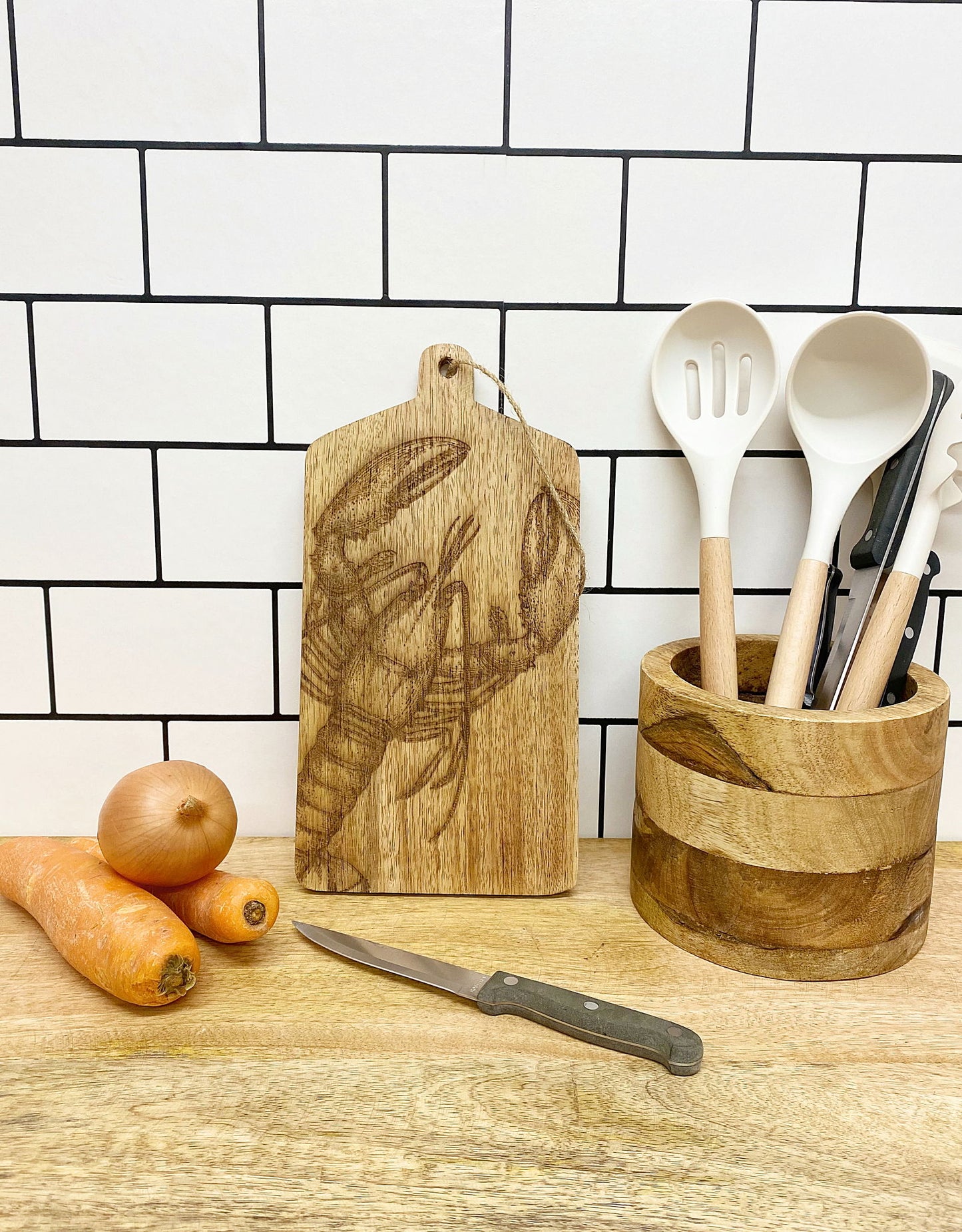 Geko Products lobster cheese board with engraved lobster design on wooden cutting board in kitchen setting