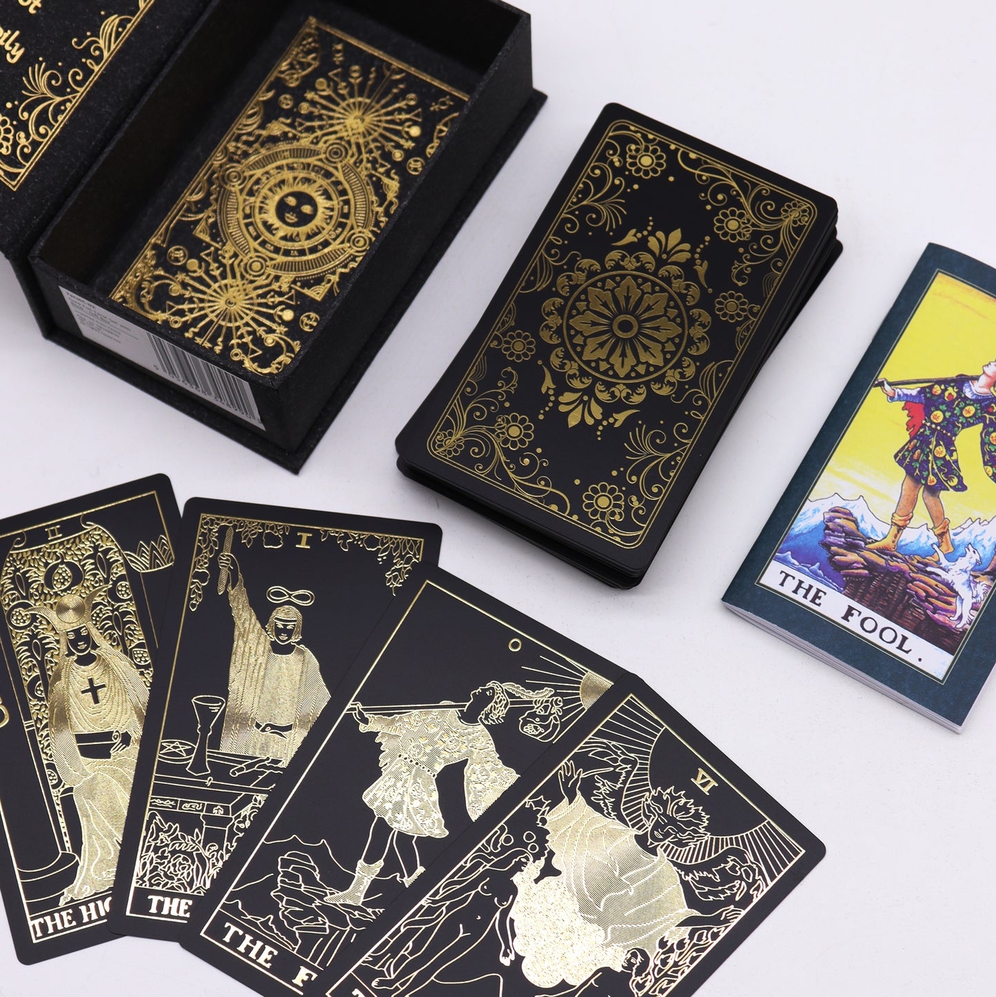 Luxury tarot card set featuring gold foil designs and a guidebook, ideal for spiritual practices