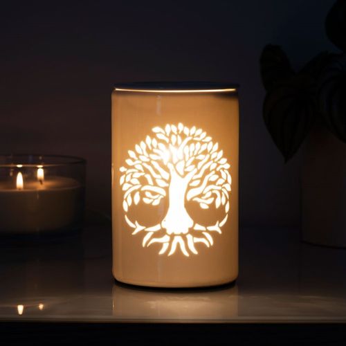 Tree of Life Electric Oil Burner illuminating a serene design on a modern lamp