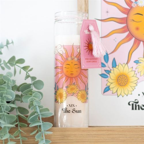 Pink grapefruit candle featuring The Sun Tarot card design with vibrant colors and floral accents