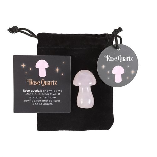 Magical rose quartz crystal mushroom displayed with a black pouch and informational tag