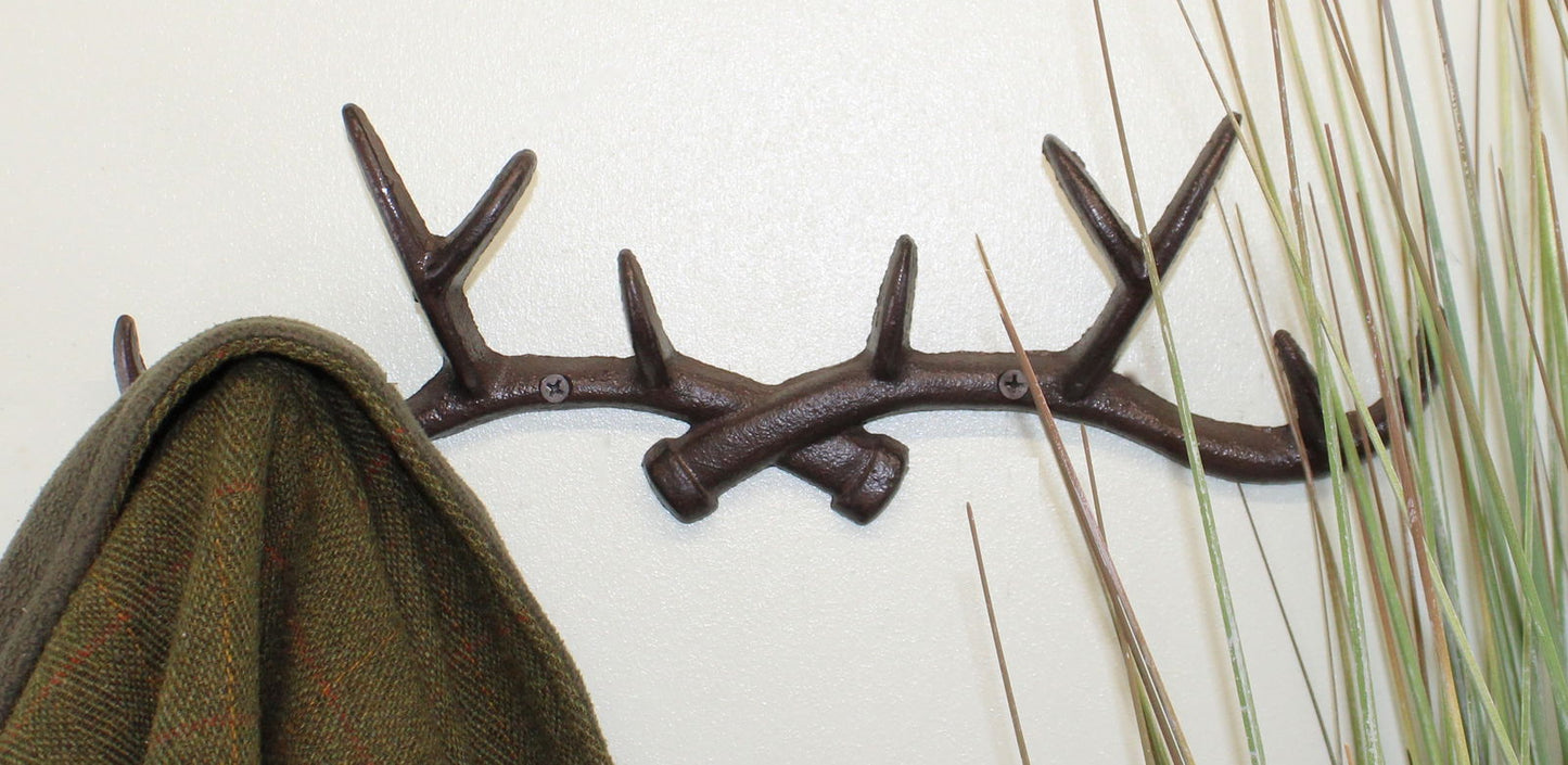 Rustic wall hooks antler design by Geko Products mounted on wall holding a coat beside decorative plants