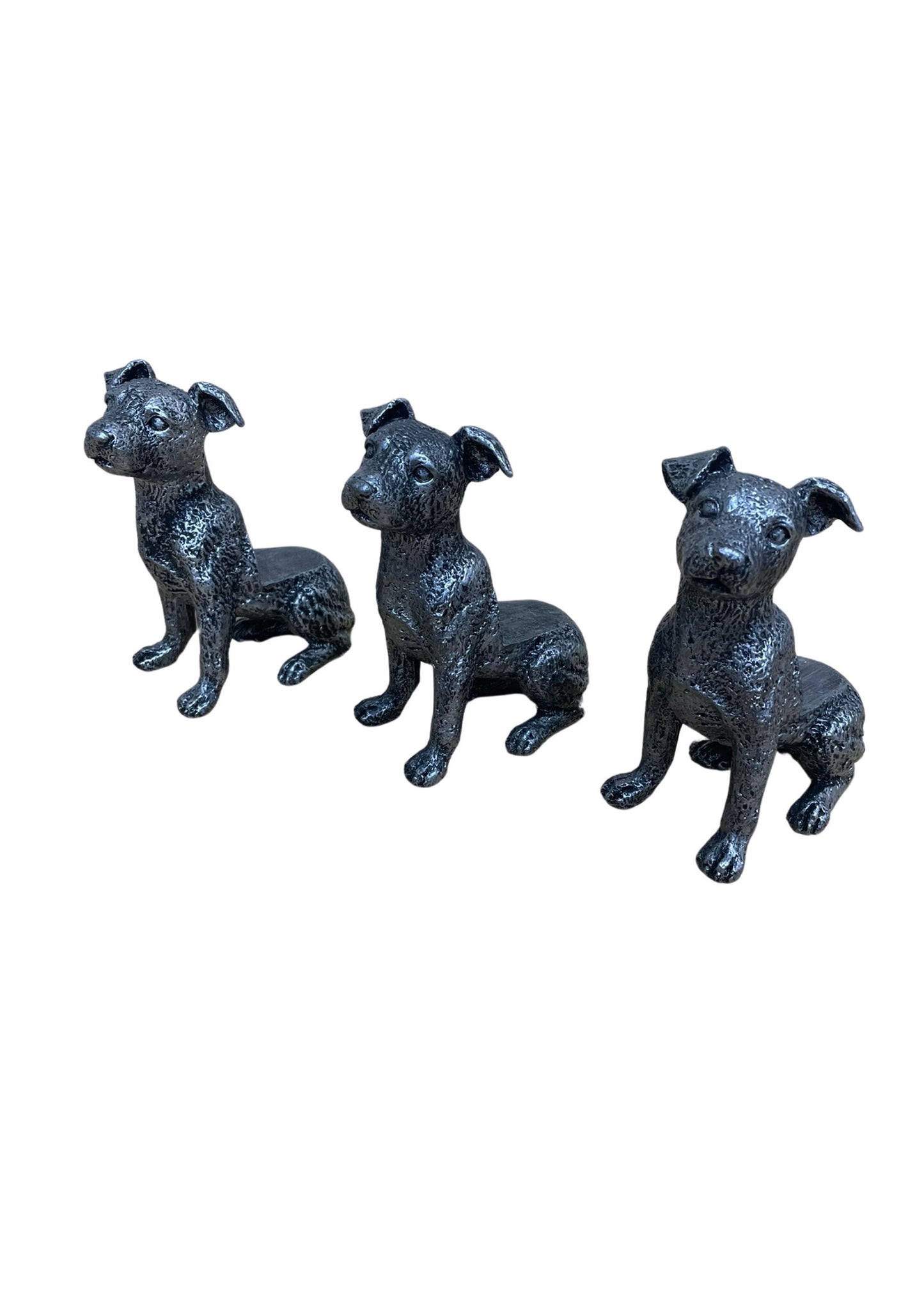 Set of three silver dog pot risers designed as sitting dogs for garden decoration