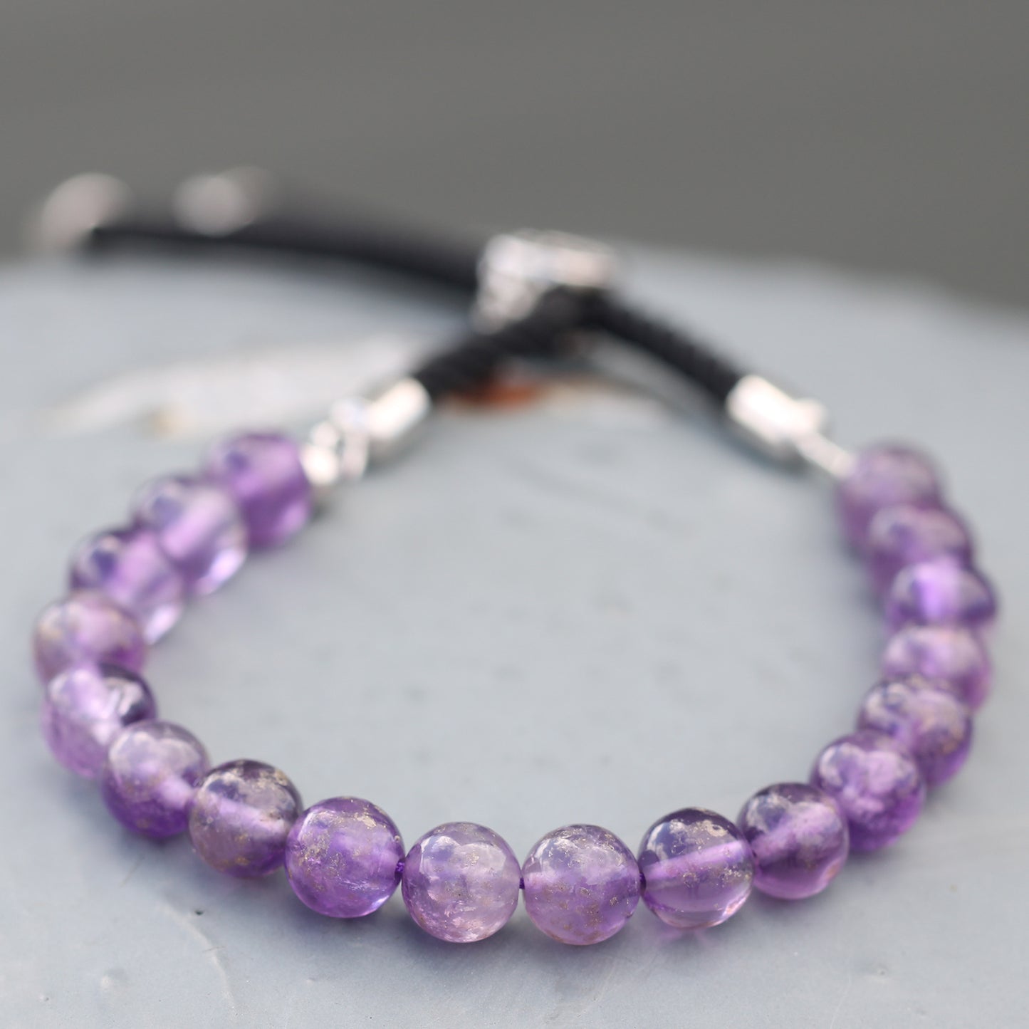 Silver Plated Gemstone Black String Bracelet featuring purple amethyst beads in a stylish design