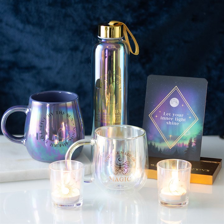 Iridescent Sun and Moon Candle Holders in a serene setting with other spiritual items from Kimchi Toki