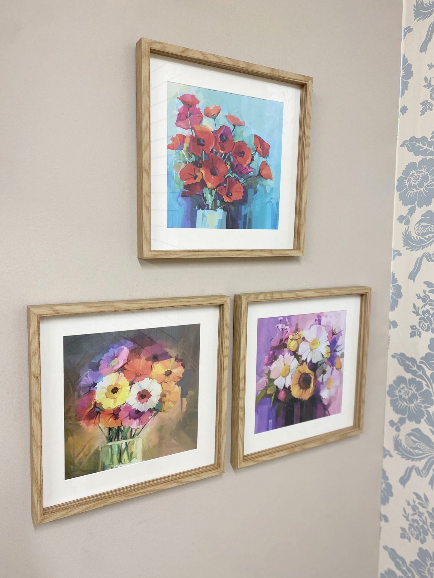 Geko Products sunburst frame set featuring three natural wood frames with colorful floral artwork