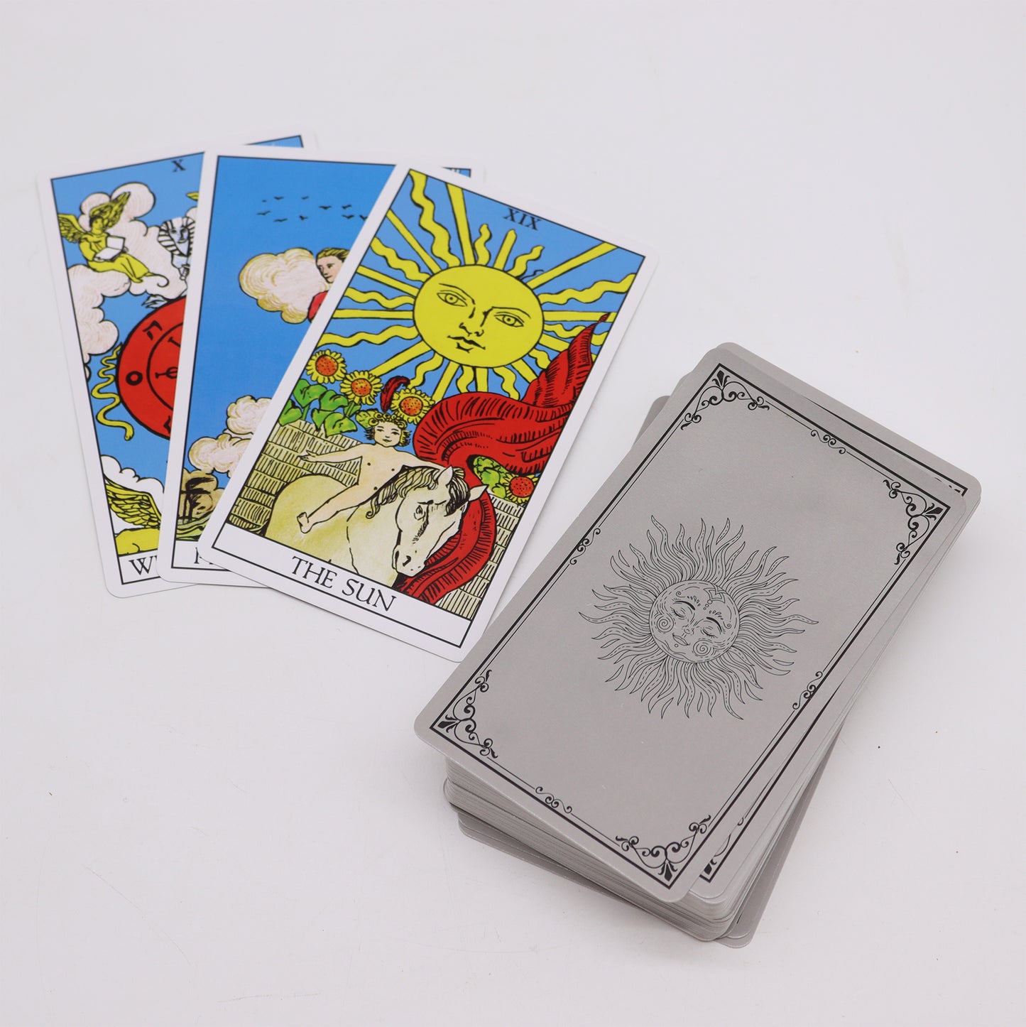 Traditional tarot cards with guidebook featuring The Sun card and vibrant imagery for intuitive readings