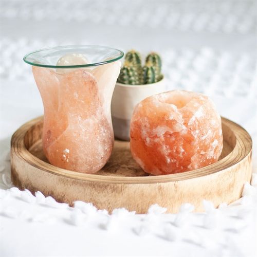 Tulip shaped oil burner made of Himalayan salt displayed on a wooden tray