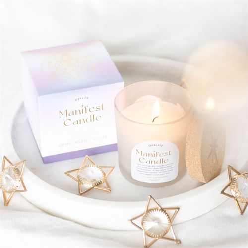 Opalite manifestation candle in a frosted glass jar, placed on a white tray with a stylish box, surrounded by decorative star accents