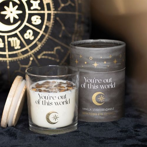 Candle with crystals in glass holder, featuring a wooden lid and decorative packaging with celestial design.