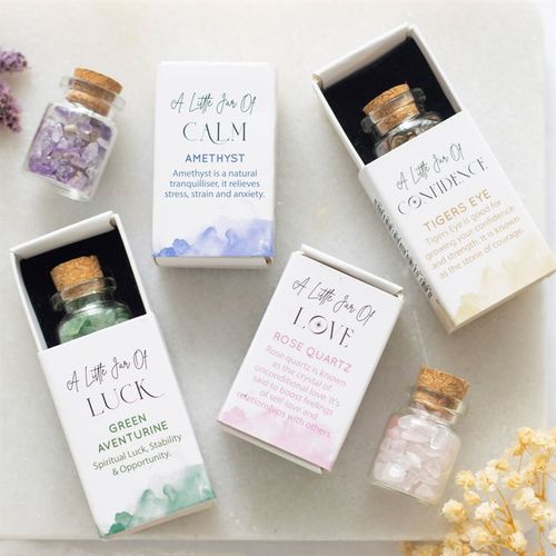 Small jar of rose quartz in matchbox, part of a crystal collection by Kimchi Toki, featuring healing properties and elegant packaging.