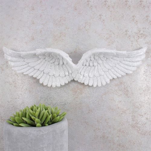 Decorative hanging glitter angel wings in white, adding a charming touch to home interiors and spiritual spaces