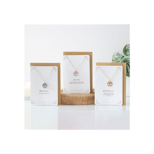 Rose gold looking tree of life necklace and card to promote friendship