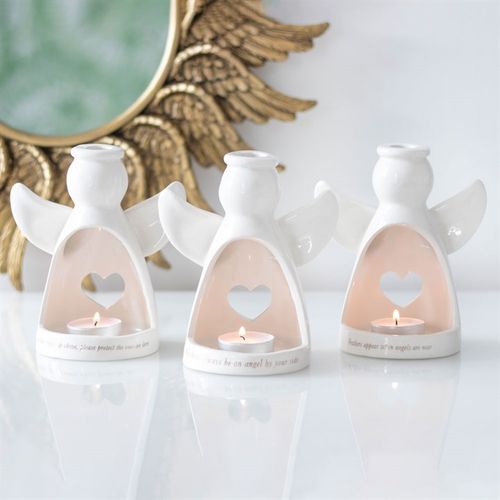Beautiful guardian angel tea light holder in white ceramic featuring heart cutouts, perfect for home decor and spirituality.