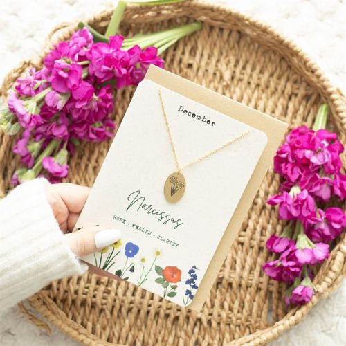 December Birth Necklace Card featuring a gold Narcissus charm on a floral-themed card, beautifully presented with flowers