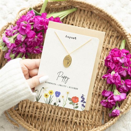 August Birth Necklace featuring a gold pendant with a poppy design on a floral card, symbolising strength and beauty
