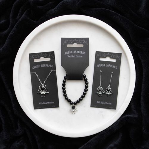 Black Spider Necklace featuring a black obsidian spider pendant, displayed with matching bracelet and earrings on an elegant plate.