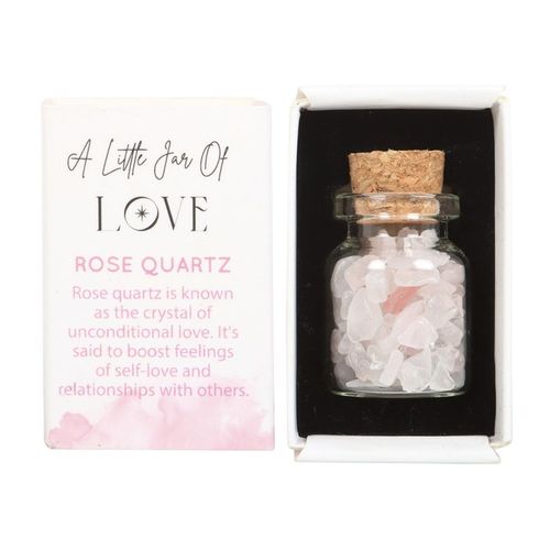 Small jar of rose quartz in matchbox featuring crystal pieces and a cork lid, symbolizing love and self-care