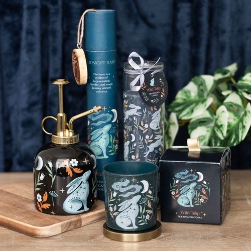 Midnight Hare Tulip Tube Candle in a decorative dark green holder with floral design, shown with accessories and packaging
