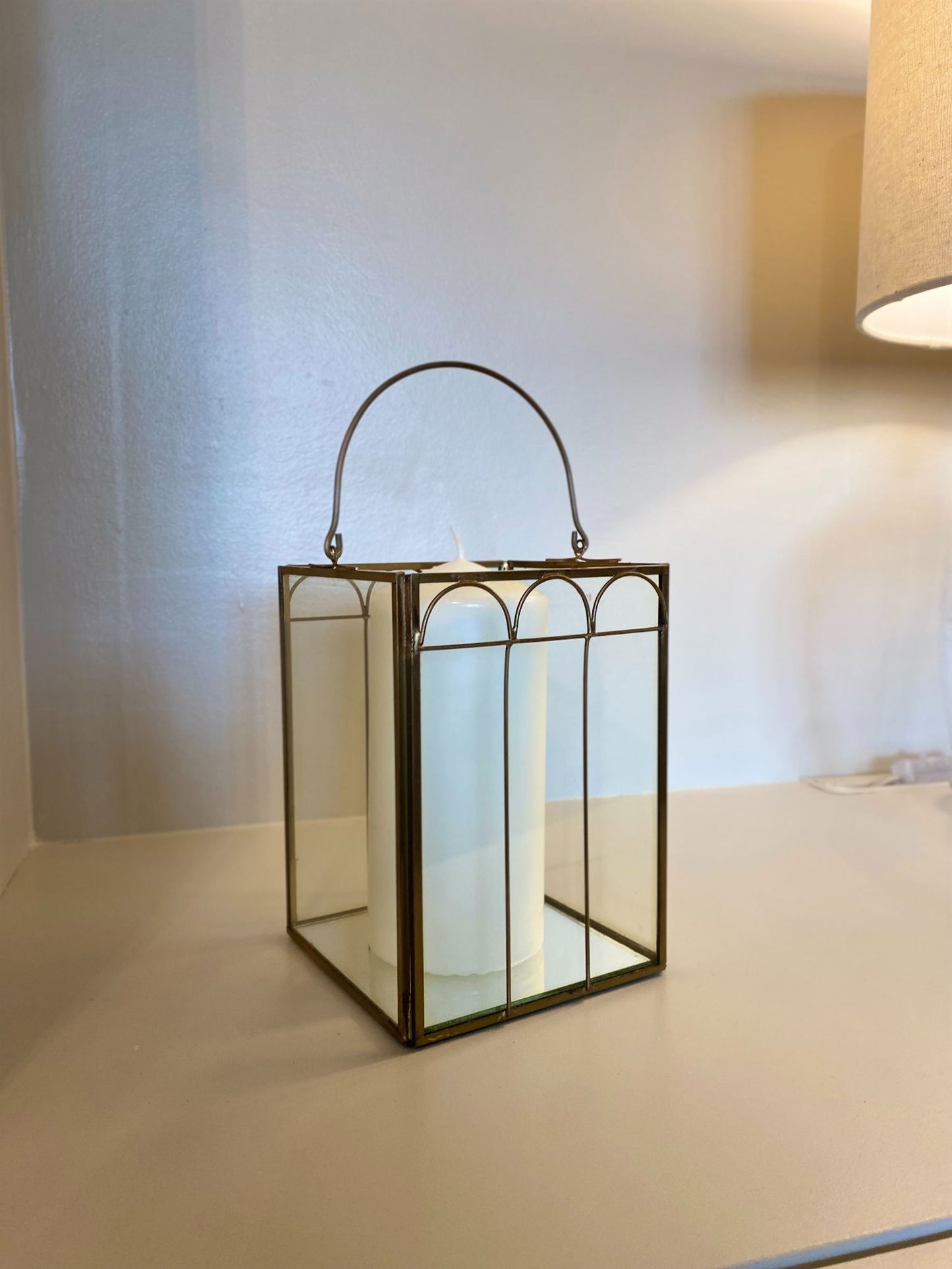 Geko Products mirrored candle lantern decor with metal frame and white candle inside on table