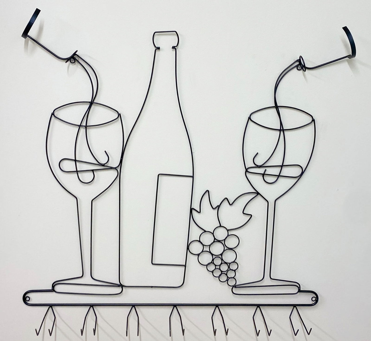 Geko Products wall mounted wine rack featuring black wire art of wine glasses bottle and grapes with multiple hooks