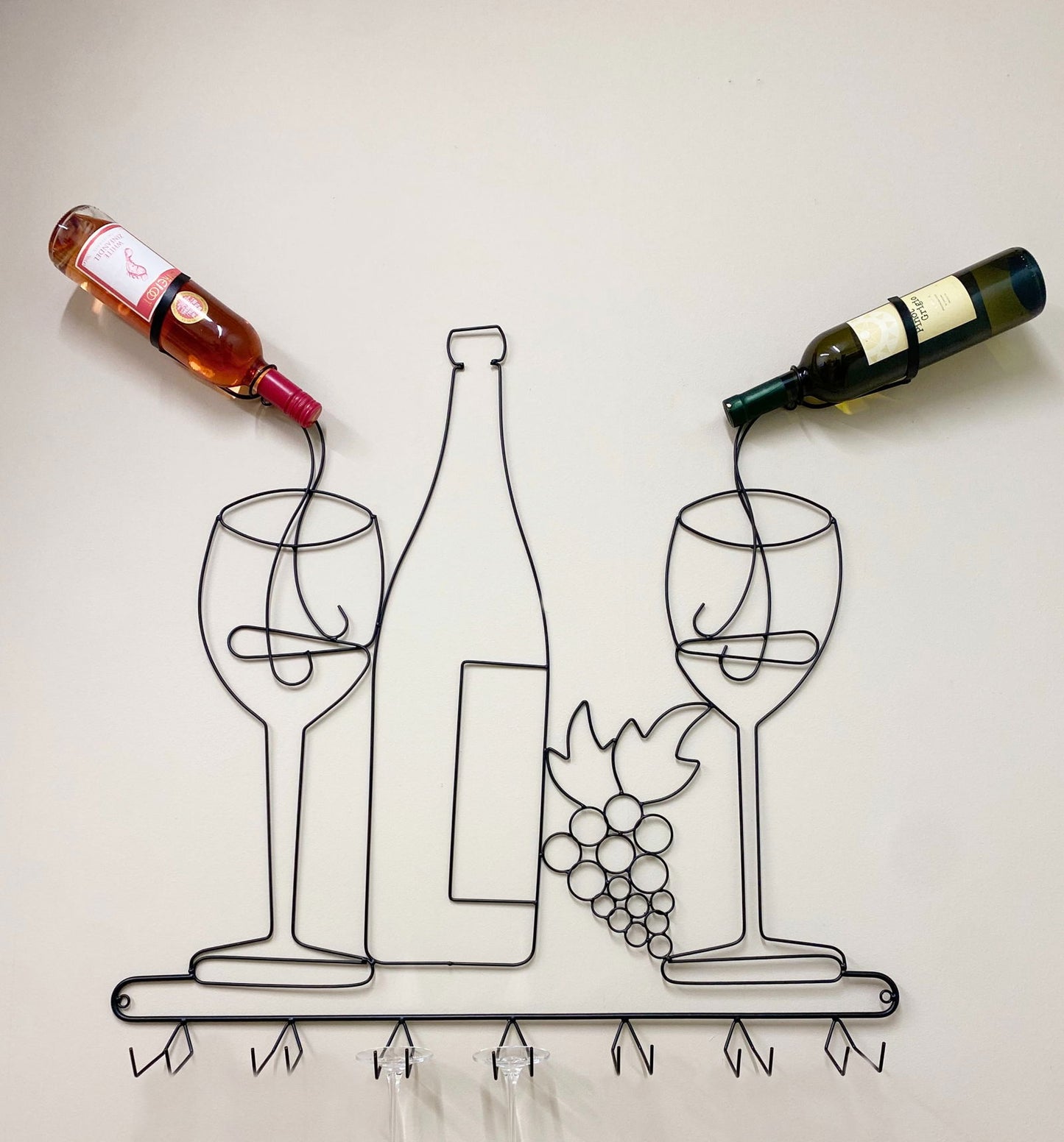 Geko Products wall mounted wine rack in black wire design holding two wine bottles and shaped like wine glasses and grapes