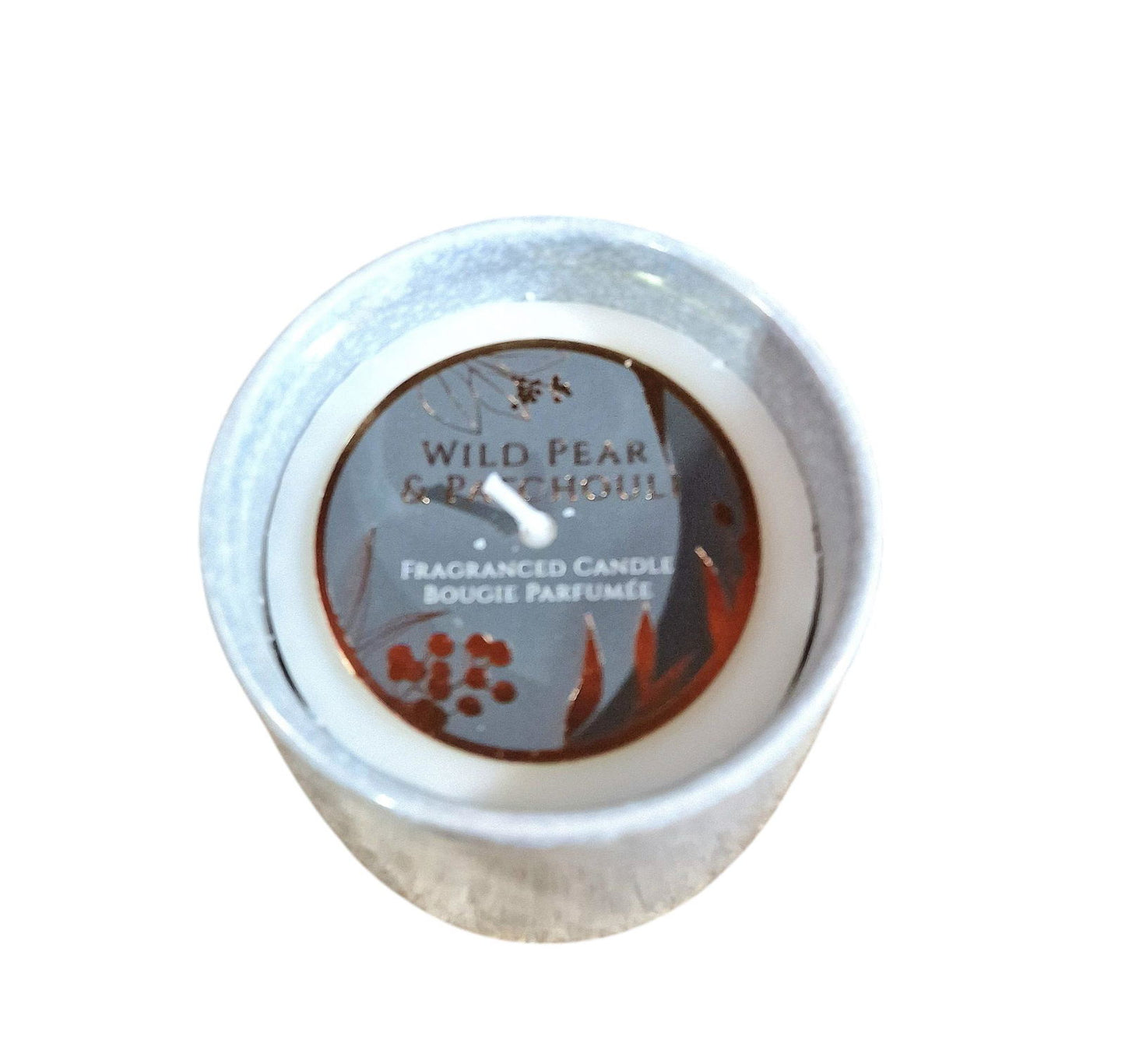 Wild pear patchouli candle by Geko Products in a small round container with floral label